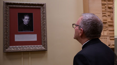 Bishop Barron looking at image of Fulton Sheen