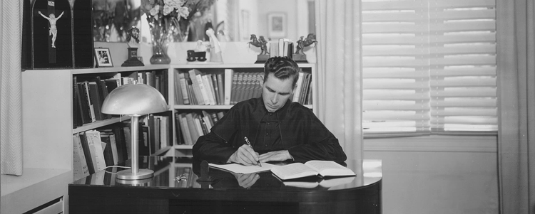 Fulton Sheen writing at his desk